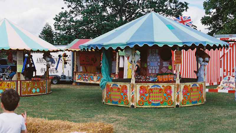 Striped fairground stalls and a Union Jack at an English village fete